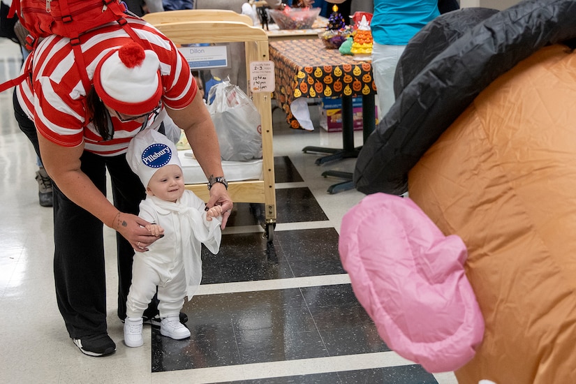 Barry. W. Hoffman, U.S. Army Financial Management Command deputy to the commander, who is dressed like Mr. Potato Head, engages with a student from a nearby childcare center at the Maj. Gen. Emmett J. Bean Federal Center Oct. 31, 2022. Students from the childcare center were able to return to their annual Halloween parade tradition for the first time since the COVID-19 pandemic. (U.S. Army photo by Mark R. W. Orders-Woempner)