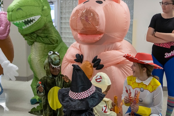 Col. Paige M. Jennings, U.S. Army Financial Management Command commander, in a pig costume, and Valerie Dillon, USAFMCOM secretary to the general staff, engage with students from a nearby childcare center at the Maj. Gen. Emmett J. Bean Federal Center Oct. 31, 2022. Students from the childcare center were able to return to their annual Halloween parade tradition for the first time since the COVID-19 pandemic. (U.S. Army photo by Mark R. W. Orders-Woempner)