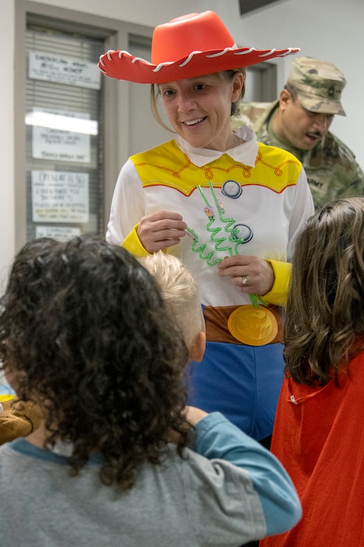 Valerie Dillon, U.S. Army Financial Management Command secretary to the general staff, engages with students from a nearby childcare center at the Maj. Gen. Emmett J. Bean Federal Center Oct. 31, 2022. Students from the childcare center were able to return to their annual Halloween parade tradition for the first time since the COVID-19 pandemic. (U.S. Army photo by Mark R. W. Orders-Woempner)