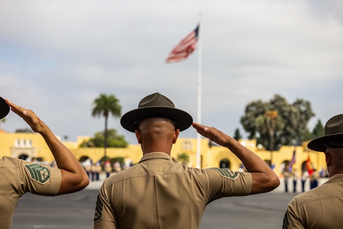 U.S. Marine Corps drill instructors salute the colors during the National Anthem at a graduation ceremony for Echo Company, 2nd Recruit Training Battalion, at Marine Corps Recruit Depot (MCRD) San Diego, Oct. 21, 2022.