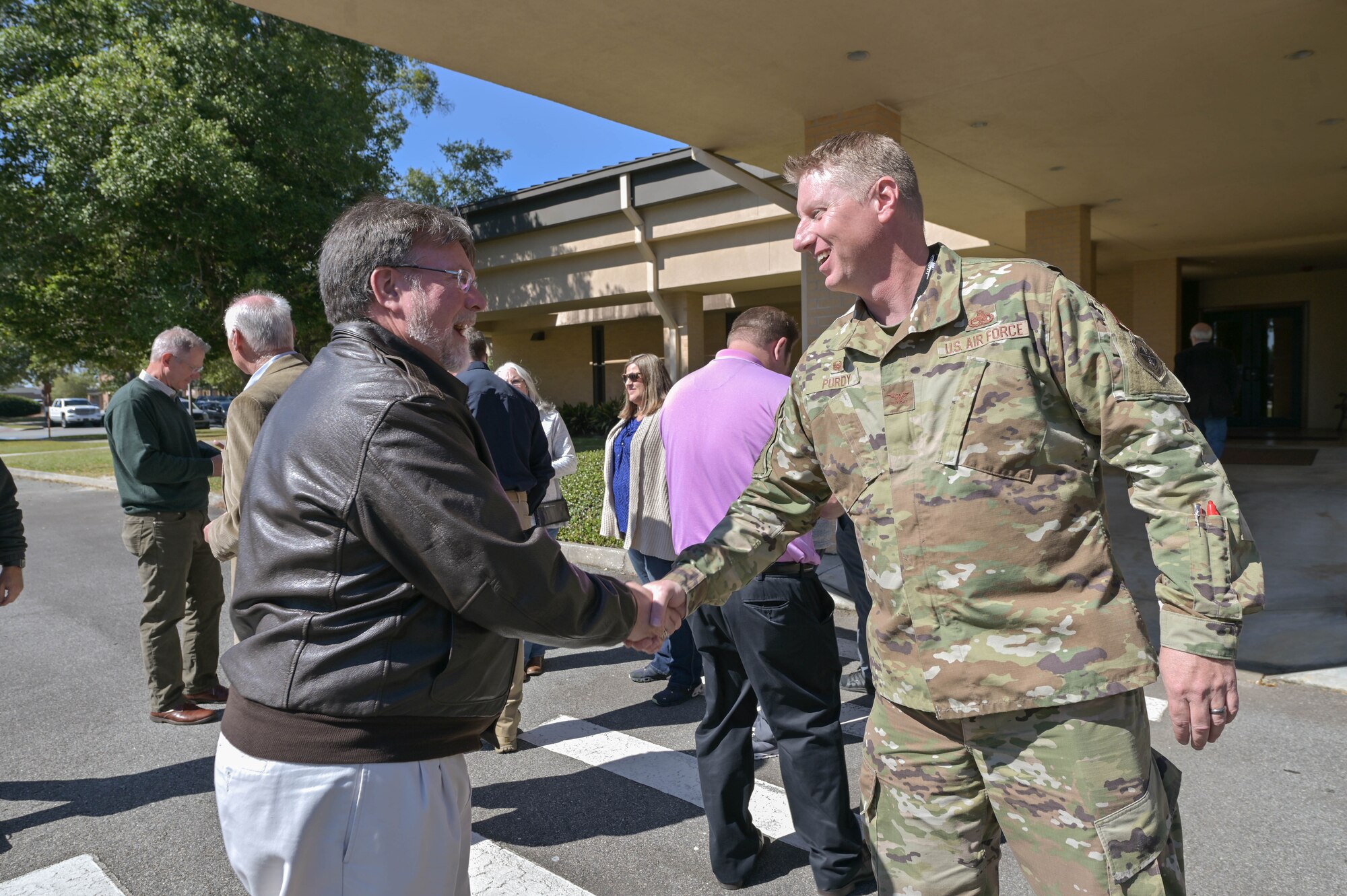U.S. Air Force Col. Jason Purdy, 23rd Maintenance Group commander, right, presents a coin to Rouse Vallotton, honorary commander alumni advisor, after a 23rd MXG immersion tour at Moody Air Force Base, Georgia, Oct. 21, 2022. The honorary commander program connects community leaders with Moody AFB leadership and personnel to build and strengthen relationships between the base and the local community. The immersion tour gave civilian leaders a behind-the-scenes look at the 23rd Wing mission and the Airmen who make the mission happen. (U.S. Air Force photo by Senior Airman Rebeckah Medeiros)