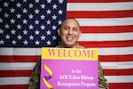 Master Sgt. William Bonner, 433rd Airlift Wing and 960th Cyberspace Wing Yellow Ribbon Program representative, holds a welcome sign for all current and future deployers to contact him about the Air Force Reserve Program Oct. 20, 2022, at Joint Base San Antonio-Lackland, Texas. (U.S. Air Force photo by Samantha Mathison)