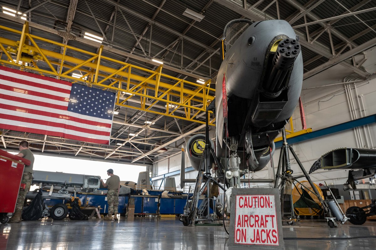 A photo of Airmen replacing an A-10 wing
