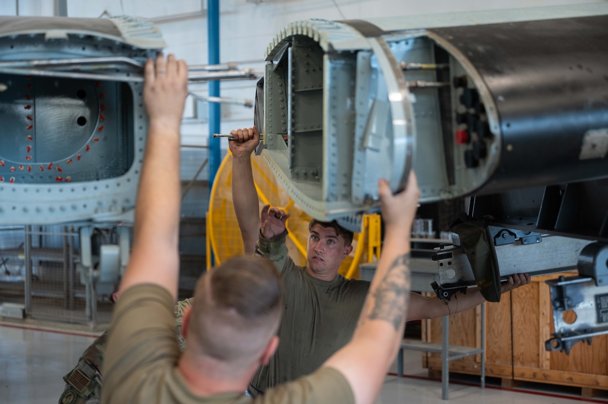A photo of Airmen replacing an A-10 wing