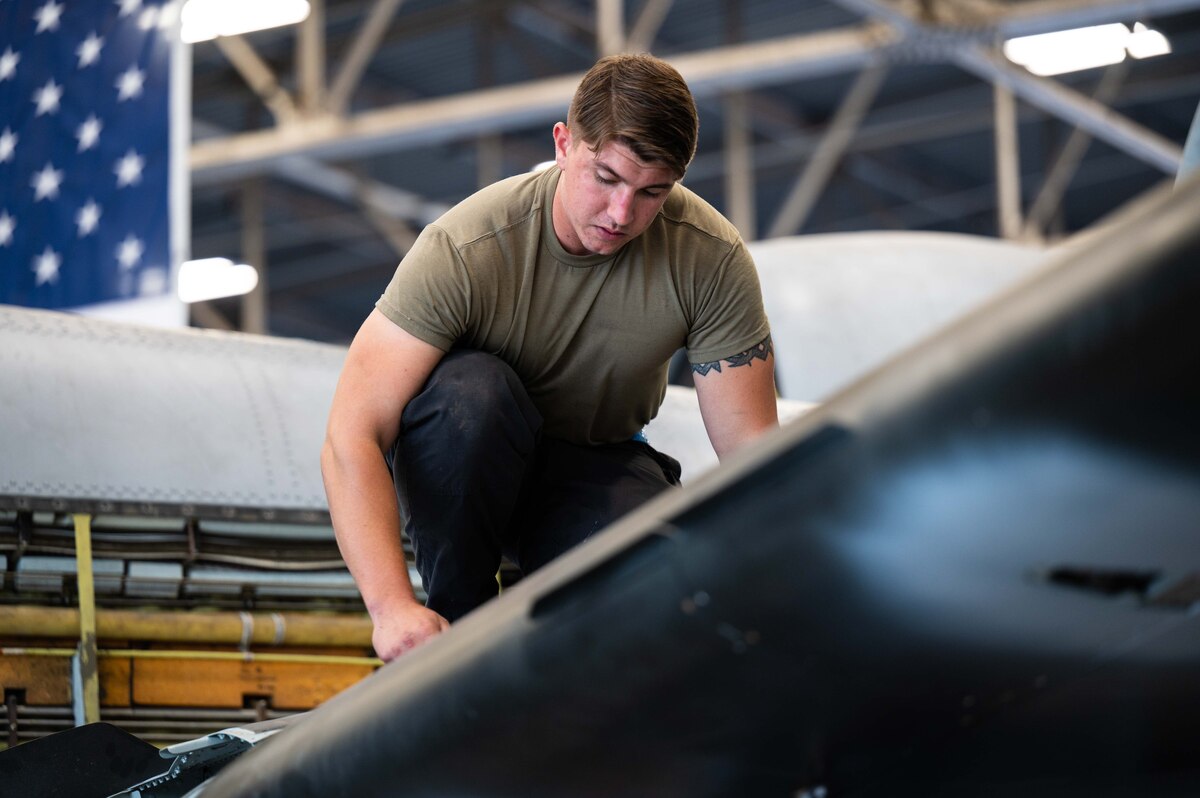 A photo of Airmen replacing an A-10 wing