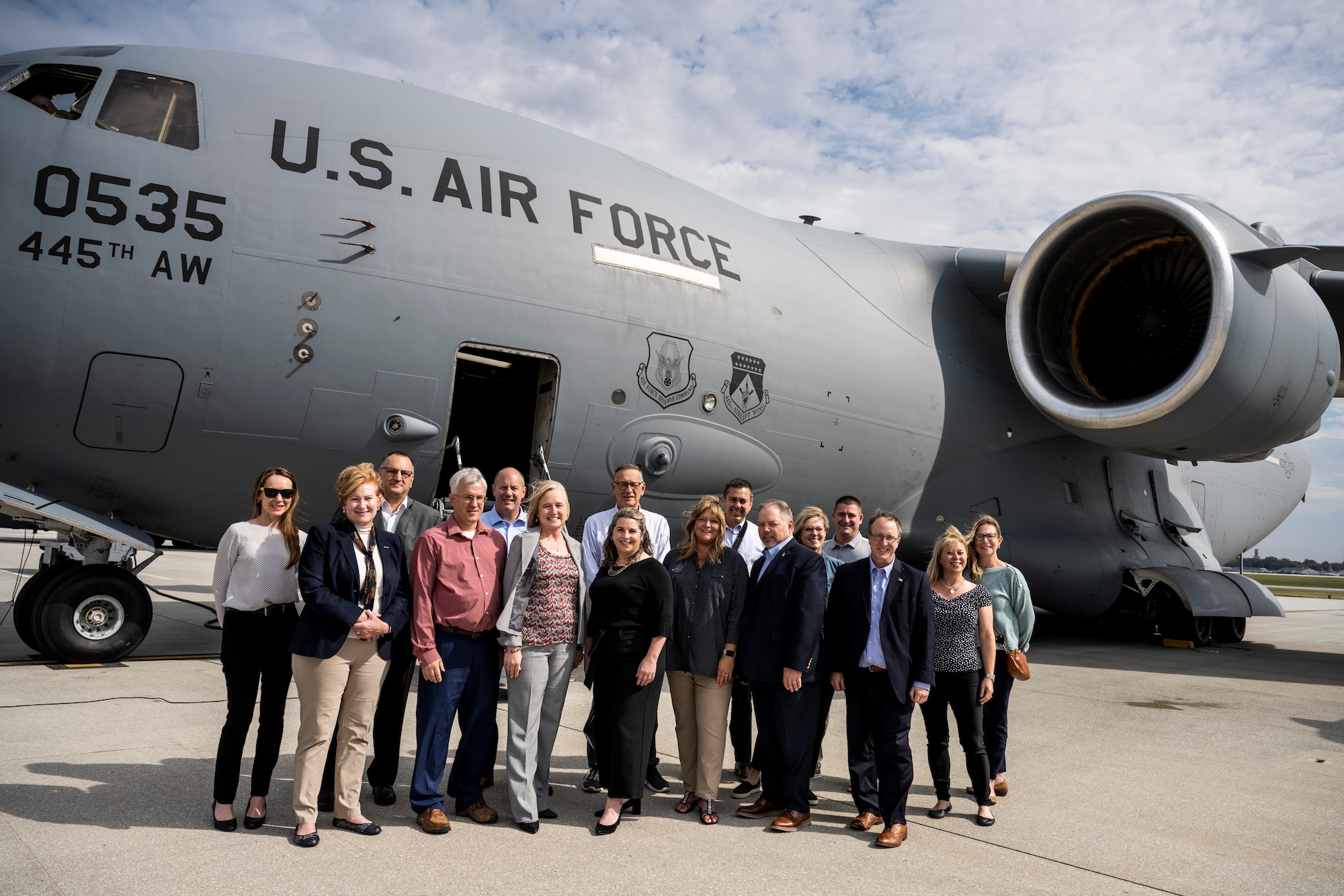 Honorary commanders group photo in front of an aircraft.