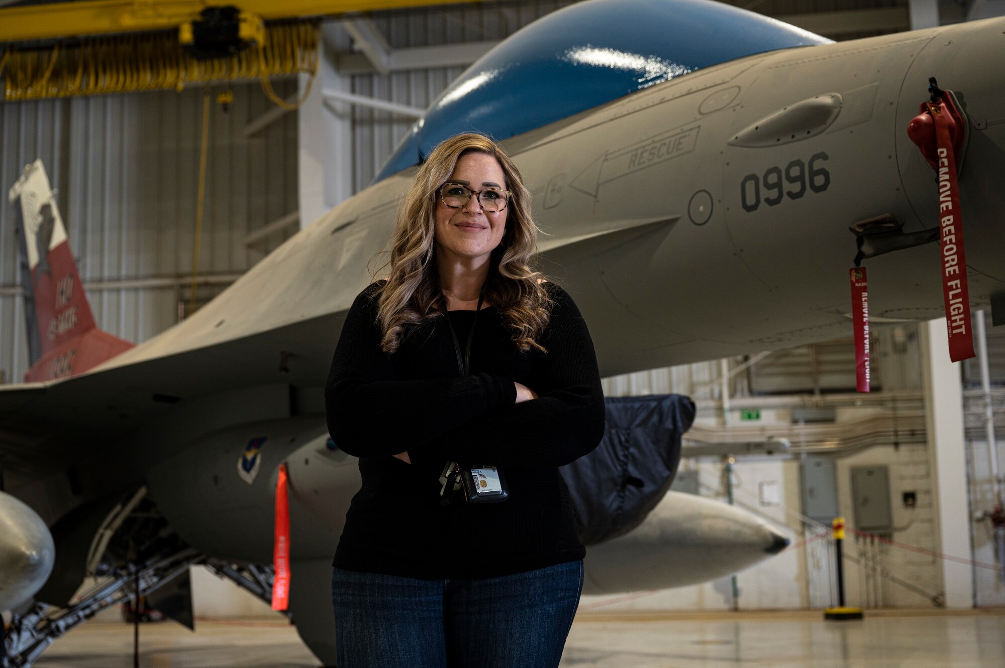 Michelle Harrell, 49th Maintenance Group unit program coordinator, poses for a photo in front of an F-16 Viper static display at Holloman Air Force Base, New Mexico, October 27, 2022. Harrell’s occupation at the 49th MXG is to provide assistance to Airmen dealing with in-processing, extensions, reenlistments and retirements. (U.S. Air Force photo by Airman 1st Class Isaiah Pedrazzini)