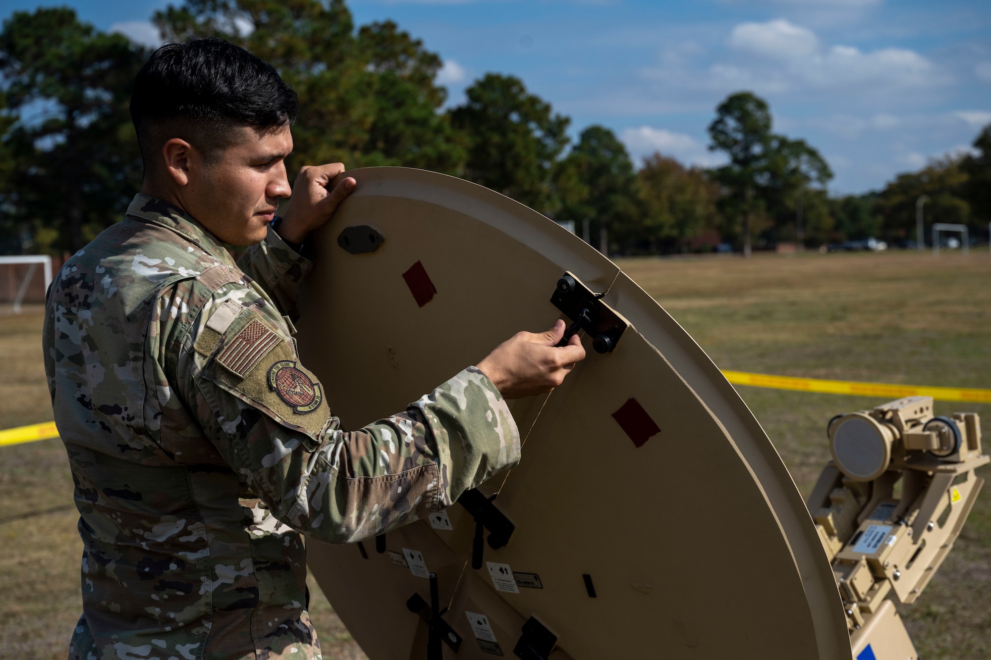 Senior Airman Carlos Juarez, 4th Communications Squadron radio frequency transmission technician, disassembles a ranger satellite during Exercise Agile Cub 22-2 at Seymour Johnson Air Force Base, North Carolina, Oct. 26, 2022. Juarez is responsible for installing and maintaining radio frequency communications, troubleshooting, and repairing communication devices, antenna systems, tuners and transmission lines. (U.S. Air Force photo by Senior Airman Kevin Holloway)
