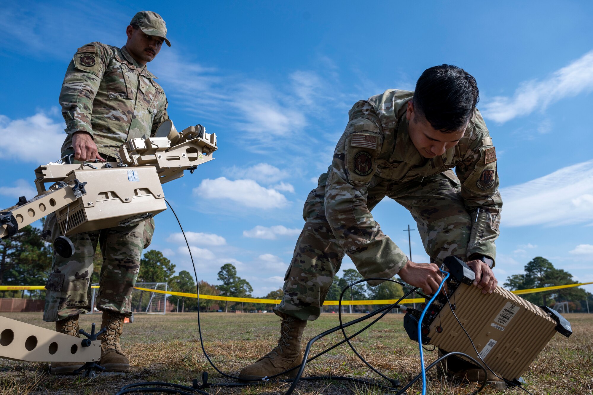 Senior Airman Noah Canary Vawter and Senior Airman Carlos Juarez,  both 4th Communications Squadron radio frequency transmission technicians, disassemble a ranger satellite during Exercise Agile Cub 22-2 at Seymour Johnson Air Force Base, North Carolina, Oct. 26, 2022. The mission of the 4th CS is to ensure effective transmissions and radio frequencies to other bases, units and partners. (U.S. Air Force photo by Senior Airman Kevin Holloway)