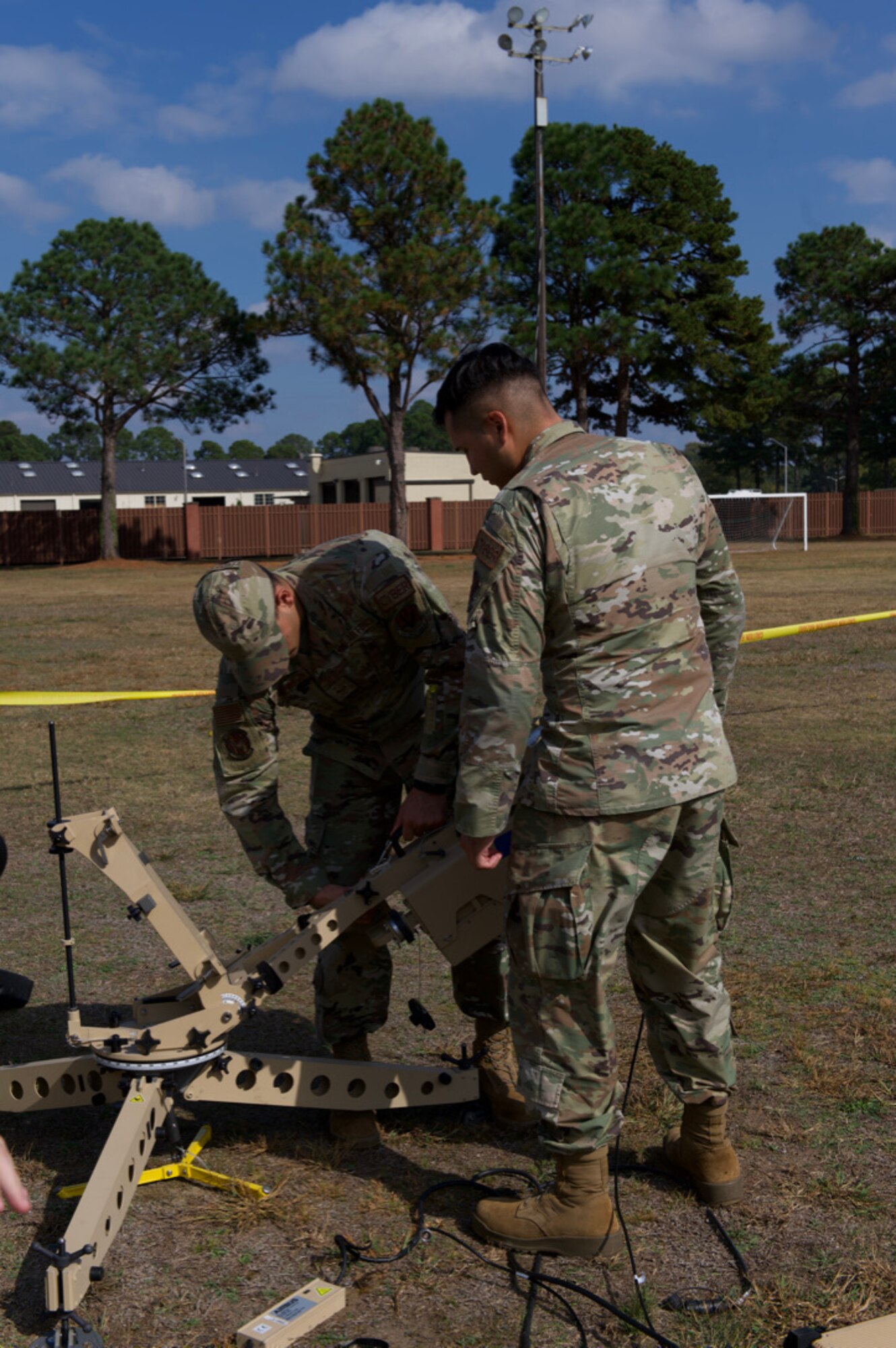 Senior Airman Carlos Juarez, 4th Communications Squadrons radio frequency technician and Senior Airman Noah Canary Vawter, 4th CS radio frequency technician, disassemble a satellite at Seymour Johnson Air Force Base, North Carolina, Oct. 26, 2022. The satellite provides internet access to troops while on deployment.   (U.S. Air Force photo by Airman 1st Class Rebecca Sirimarco-Lang)
