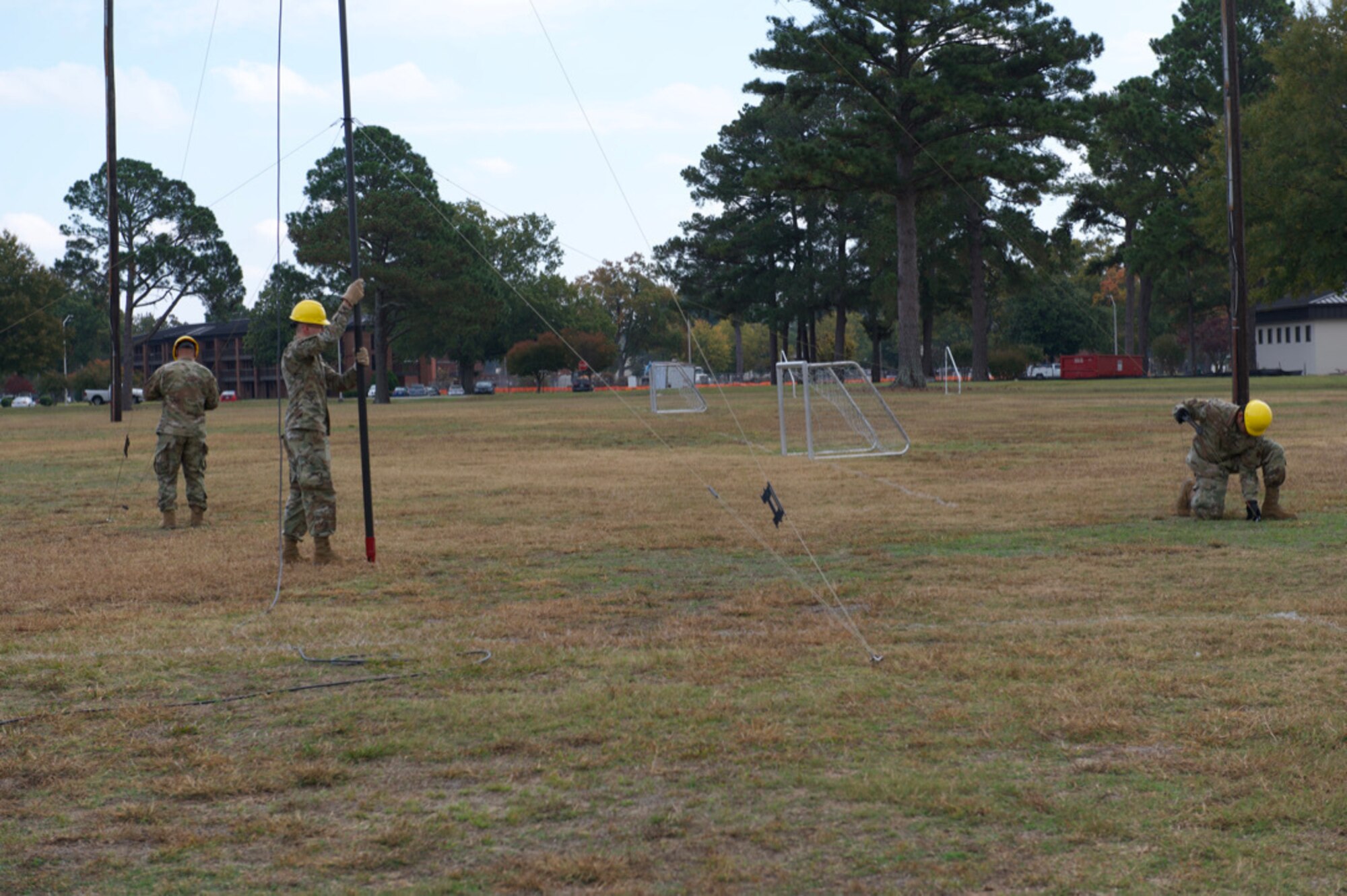 Airmen assigned to the 4th Communications Squadron disassemble an antenna system at Seymour Johnson Air Force Base, North Carolina, Oct. 26, 2022. The Airmen tested their ability to assemble and disassemble equipment needed for possible deployment. (U.S. Air Force photo by Airman 1st Class Rebecca Sirimarco-Lang)