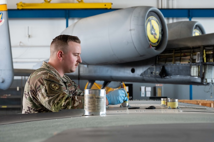 A photo of Airmen replacing an A-10 wing