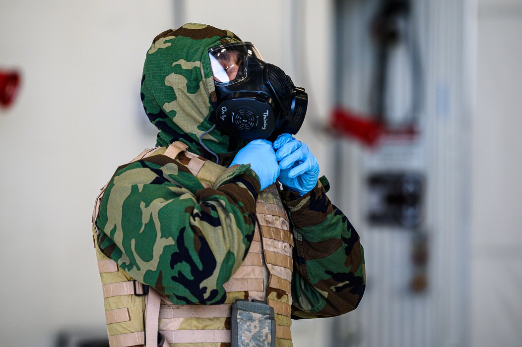 U.S. Air Force Airman 1st Class Bryan Arancibia, 355th Aircraft Maintenance Unit crew chief, puts on Mission Oriented Protective Posture level 4 gear during a mini generation on Eielson Air Force Base, Alaska, Oct. 26, 2022.