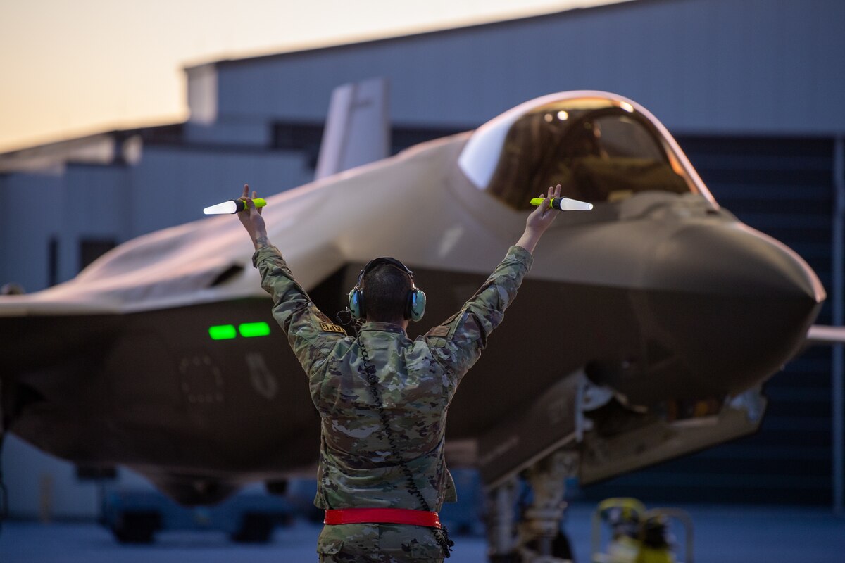 A crew chief assigned to the 158th Fighter Wing taxis an F-35A Lightning II fifth generation aircraft assigned to the wing at the Vermont Air National Guard Base, South Burlington, Vermont, May 2, 2022. The aircraft departed to Spangdahlem Air Base, Germany, to continue NATO’s Enhanced Air Policing mission along the Eastern Flank.