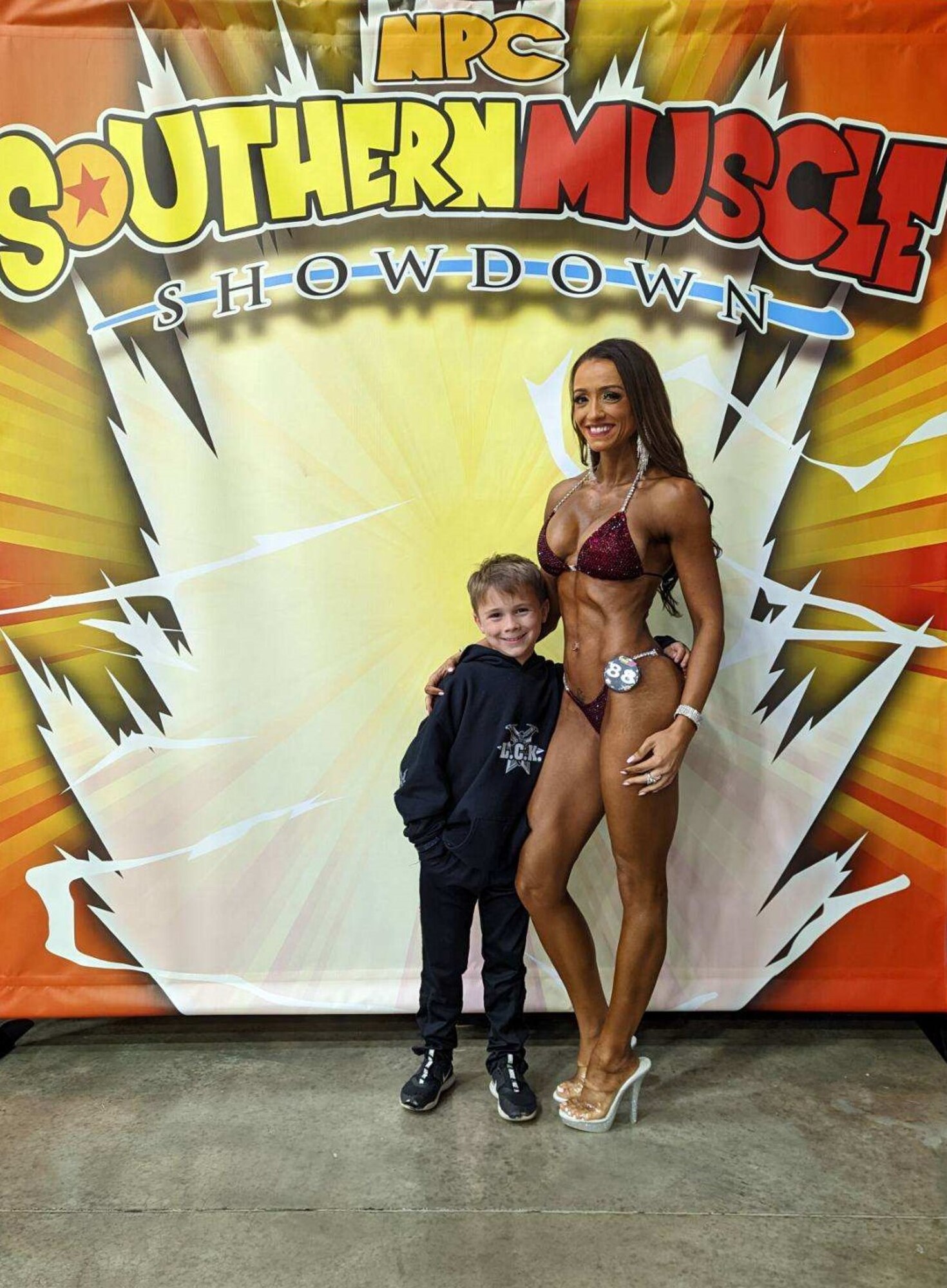 Recruiter poses with her son after winning five first place medals at the National Physique Committee Southern Muscle Showdown National Qualifier at Dalton Convention Center in Georgia, Oct. 1, 2022