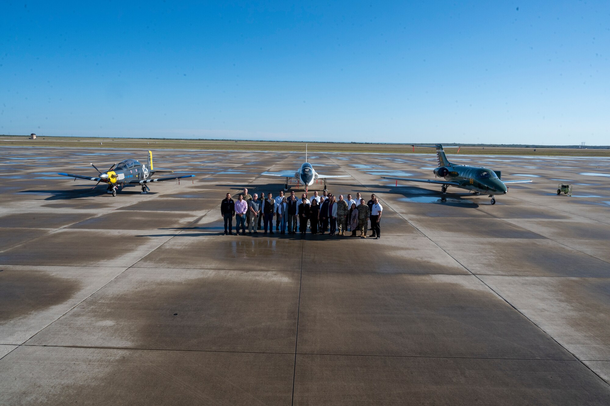 Laughlin leadership and distinguished visitors from Del Rio, Texas, and  Ciudad Acuna, Mexico, stand for a group photo in front of a T-1 Jayhawk, T-38C Talon, and a T-6A Texan II at Laughlin Air Force Base, Texas, Nov. 1, 2022. Laughlin’s mission is to develop U.S. Air Force pilots and the base relies on support from the local community to make that mission a success. Familiarization tours cultivate understating of the wing’s mission and help forge lasting partnerships in the community.  (U.S. Air Force photo by Senior Airman Nicholas Larsen)