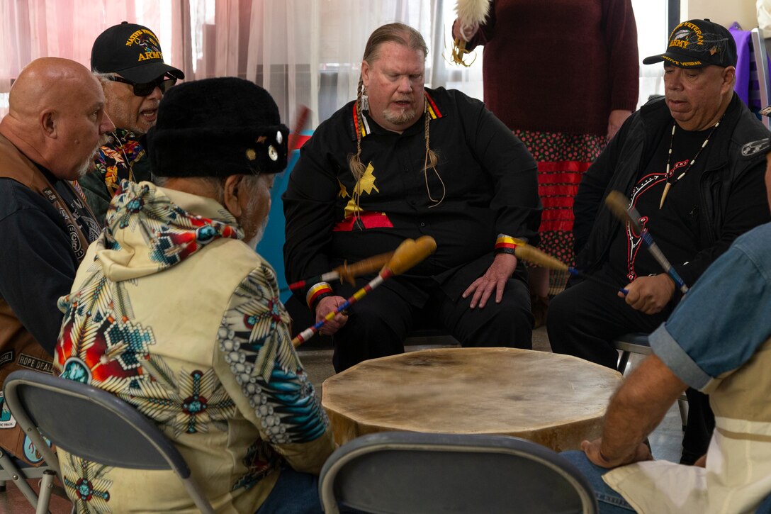 A group of attendees and veterans perform with a ceremonial drum during the National American Indian Heritage Month opening ceremony on Edwards AFB. From Nov. 1-30, the observance month recognizes American Indians for their respect for natural resources and the Earth, having served with valor in our nation's conflicts and for their many distinct and important contributions to the United States.