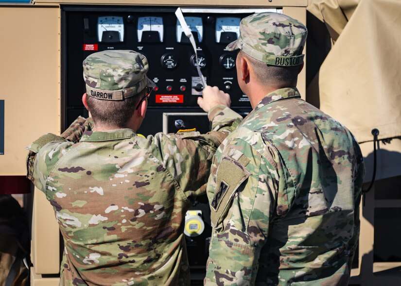 Soldiers examine equipment.