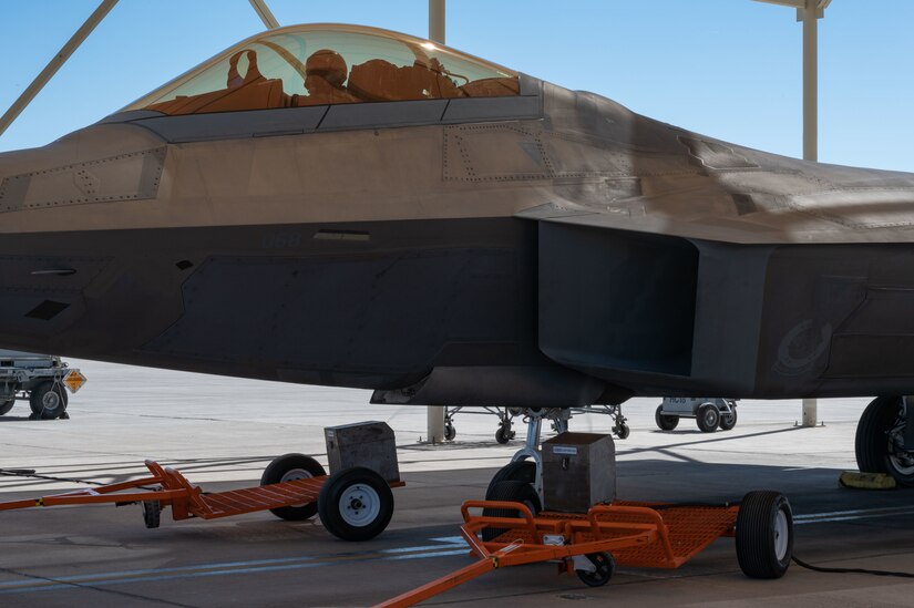 Wintergreen oil is sprayed into the intake of an F-22