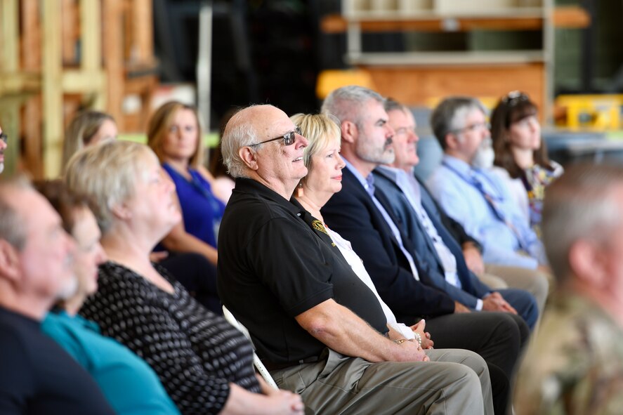 Mr Stan Sluggo Siefke sits with attendees while listening to remarks during the AC-130J Ghostrider Dedication and Delivery Ceremony Nov. 2, 2022, at Bob Sikes Airport in Crestview, Florida. The aircraft, which was the final one delivered of the 31 purchased by the US Air Force, was nicknamed after Sluggo because of his instrumental work in the development of the aircraft’s precision strike package.