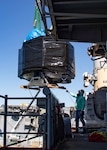 Kenya Latham, assigned to East Coast Repair, coordinates the on load of a three dimensional printer aboard the Wasp-class amphibious assault ship USS Bataan (LHD 5), Oct. 19, 2022.