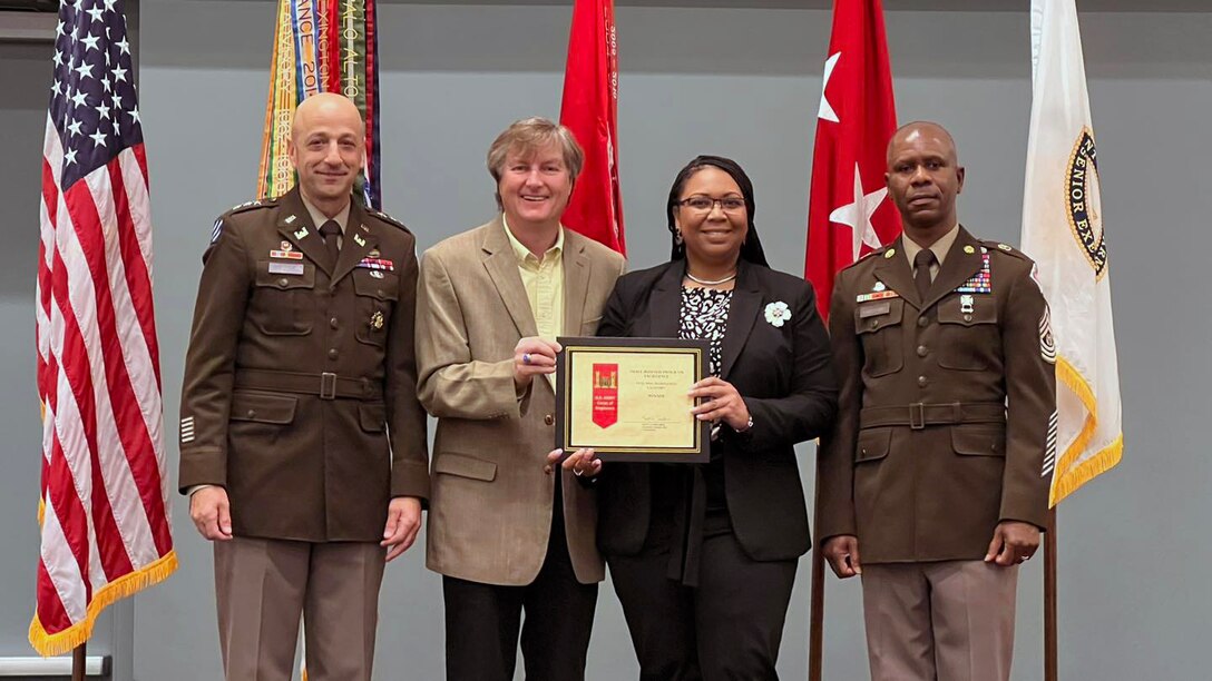 (Left to Right) Lt. Gen. Scott Spellmon, USACE 55th Commanding General, presents Tim Murphy, U. S. Army Corps of Engineers, Jacksonville District, Deputy District Engineer for Project Management, Kimberly Daniel-Ray, Jacksonville District Deputy Small Business chief, with a Small Business Award at the SAME small business convention.  Looking on is U.S. Army Corps of Engineers' senior enlisted adviser Command Sgt. Maj. Patrickson Toussaint. (USACE photo by Leon Roberts)