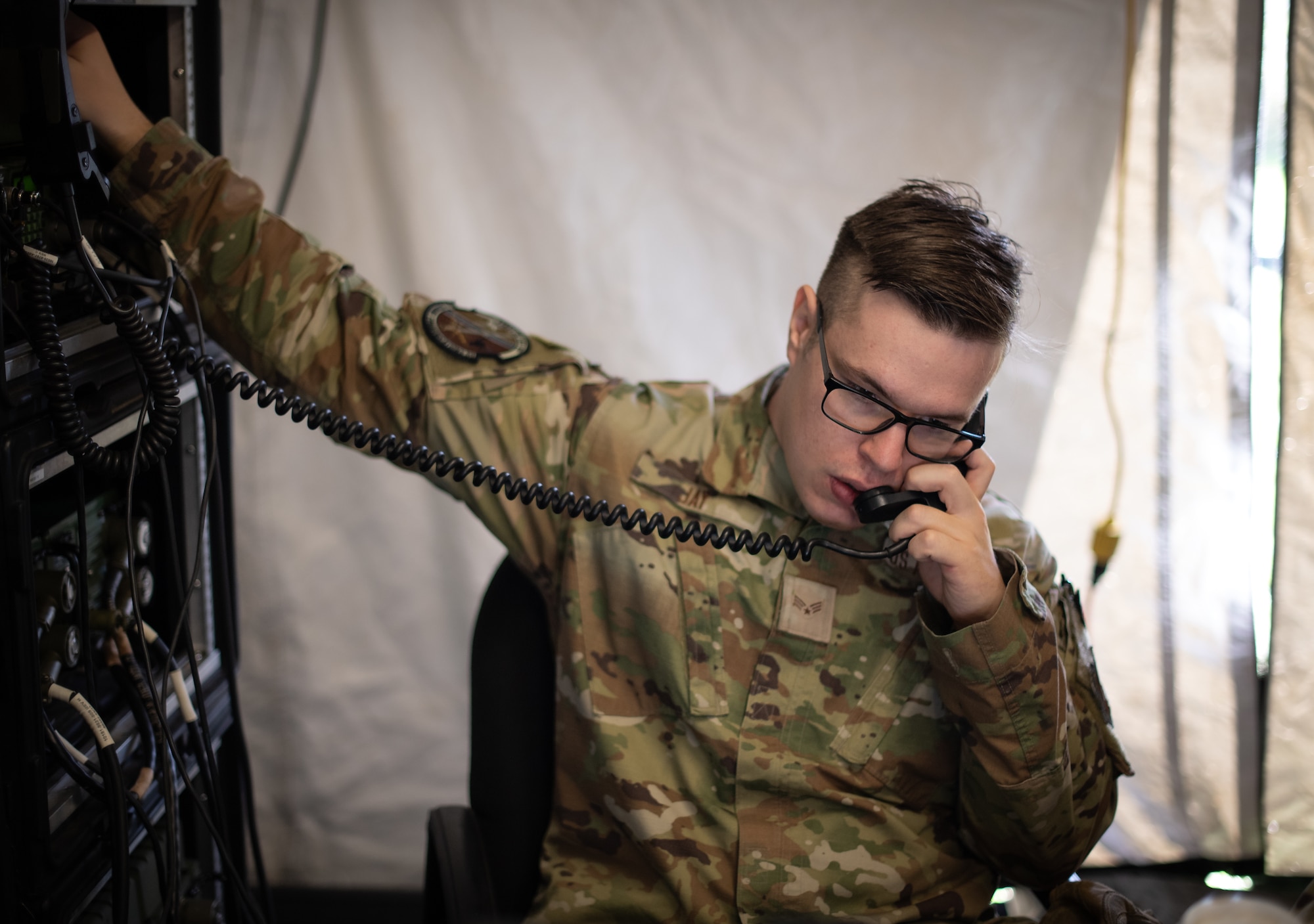 U.S. Air Force Senior Airman Kelly Jay, 1st Combat Communications Squadron radio frequency transmission systems technician, operates a high-frequency radio stack to communicate with other military radio stations during Noble Skywave at U.S. Army Garrison Baumholder, Germany, Germany, Oct. 26, 2022. Noble Skywave is a global contest in which first place is given to the military unit that is able to get in contact with the most radio stations by using high-frequency radio technology. (U.S. Air Force photo by Airman 1st Class Jared Lovett)