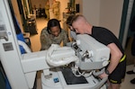 Air Force Staff Sgt. Moneque English, an instructor in the Medical Education and Training Campus Radiologic Technologist program, instructs students on how to use a portable x-ray machine. English was recognized for her contributions to the Columbus State University track and field and cross-country teams by being inducted into the school's athletic hall of fame during a ceremony Oct. 1, 2022.