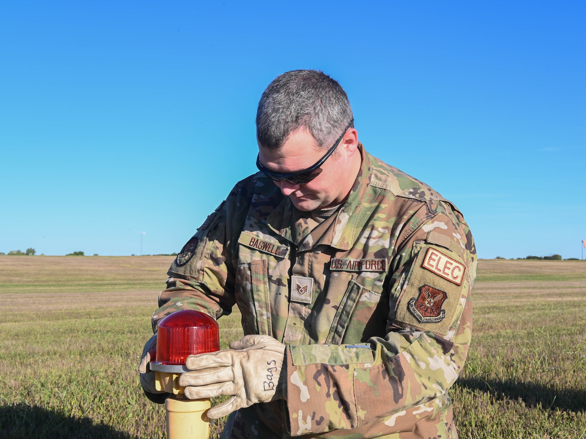 U.S. Air Force Staff Sgt. Kyle Bagwell, 509th Civil Engineering Squadron Electrical Systems Craftsman, completing the alignment of a temporary threshold light at Whiteman Air Force Base, September 26, 2022. (U.S. Air Force photo by Airman 1st Class Hailey Farrell)