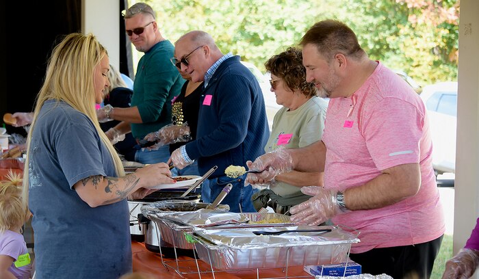 U.S. Army Space and Missile Defense Command volunteers serve lunch to surviving family members during the Survivor Outreach Services Fall Festival at the Morale, Welfare and Recreation activity field on Redstone Arsenal, Alabama, Oct. 15. (U.S. Army photo by Carrie David Campbell)