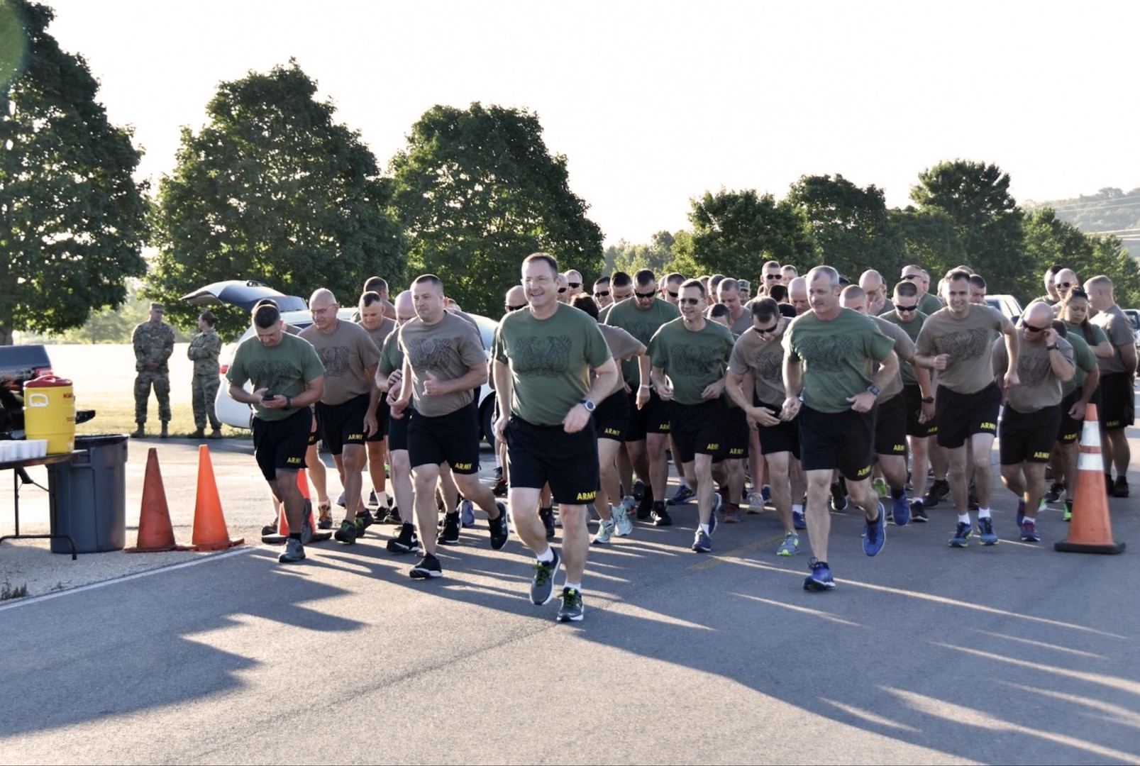 Chief Warrant Officer Five (CW5) Patrick J. Muenks leads runners during an event commemorating the 100th year of the Warrant Officer Cohort.