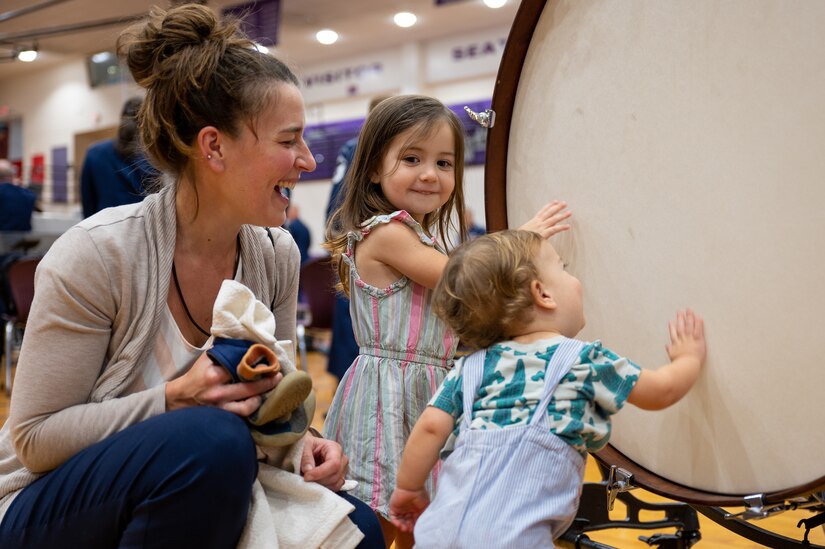 The Cochran family test a drum at The United States Air Force Band’s Fall Tour concert at South Eugene High School, Eugene, Ore., Oct. 26, 2022. The Band’s live performances attracted thousands of audience members from across the Pacific Northwest region. (U.S. Air Force photo by Kristen Wong)