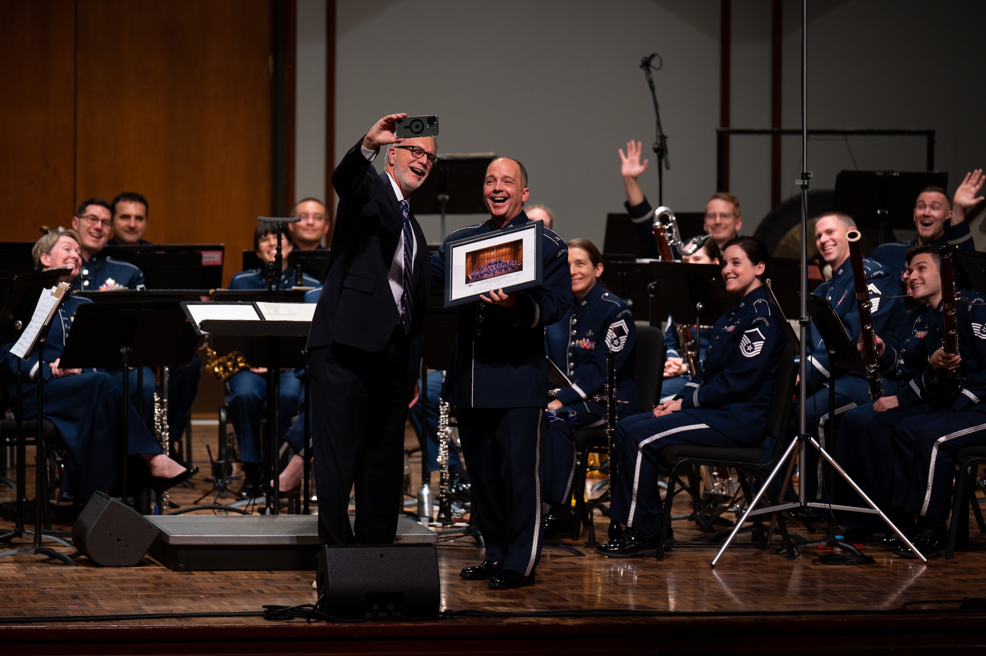 U.S. Air Force Col. Don Schofield poses for a selfie with the president of George Fox University, Robin Baker, after presenting him with a commemorative photo during The United States Air Force Band’s Fall Tour concert at George Fox University, Newberg, Ore., Oct. 25, 2022. The Band’s mission is to honor those who have served, inspire American citizens to heightened patriotism and service, and positively impact the global community on behalf of the U.S. Air Force and the United States of America. (U.S. Air Force photo by Kristen Wong)
