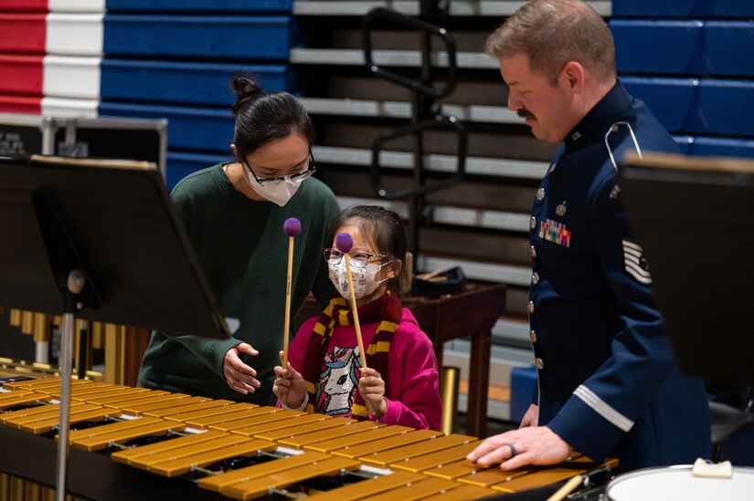 U.S. Air Force Tech. Sgt. Bradley Robinson shows audience members how to play the vibraphone during intermission at The United States Air Force Band’s Fall Tour concert at Juanita High School, Kirkland, Wash., Oct. 22, 2022. Audience members were able to speak with members of The Band one-on-one, test instruments and learn more about The Band’s mission during intermission and before and after each concert. (U.S. Air Force photo by Kristen Wong)