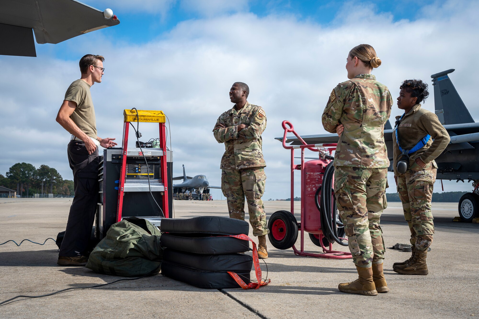 Chaplain Pierre St. Louis, 4th Fighter Wing, and Airman 1st Class Alyssa Ellis, 4th FW religious affairs specialist, speak with Airmen assigned to the 4th Fighter Generation Squadron at Seymour Johnson Air Force Base, North Carolina, Nov. 3, 2022. Religious service teams engage with units across the base to promote healthy engagements, provide services and promote positive morale within squadrons. (U.S. Air Force photo by Airman 1st Class Sabrina Fuller)