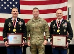 Photo of three men posing in military uniform.