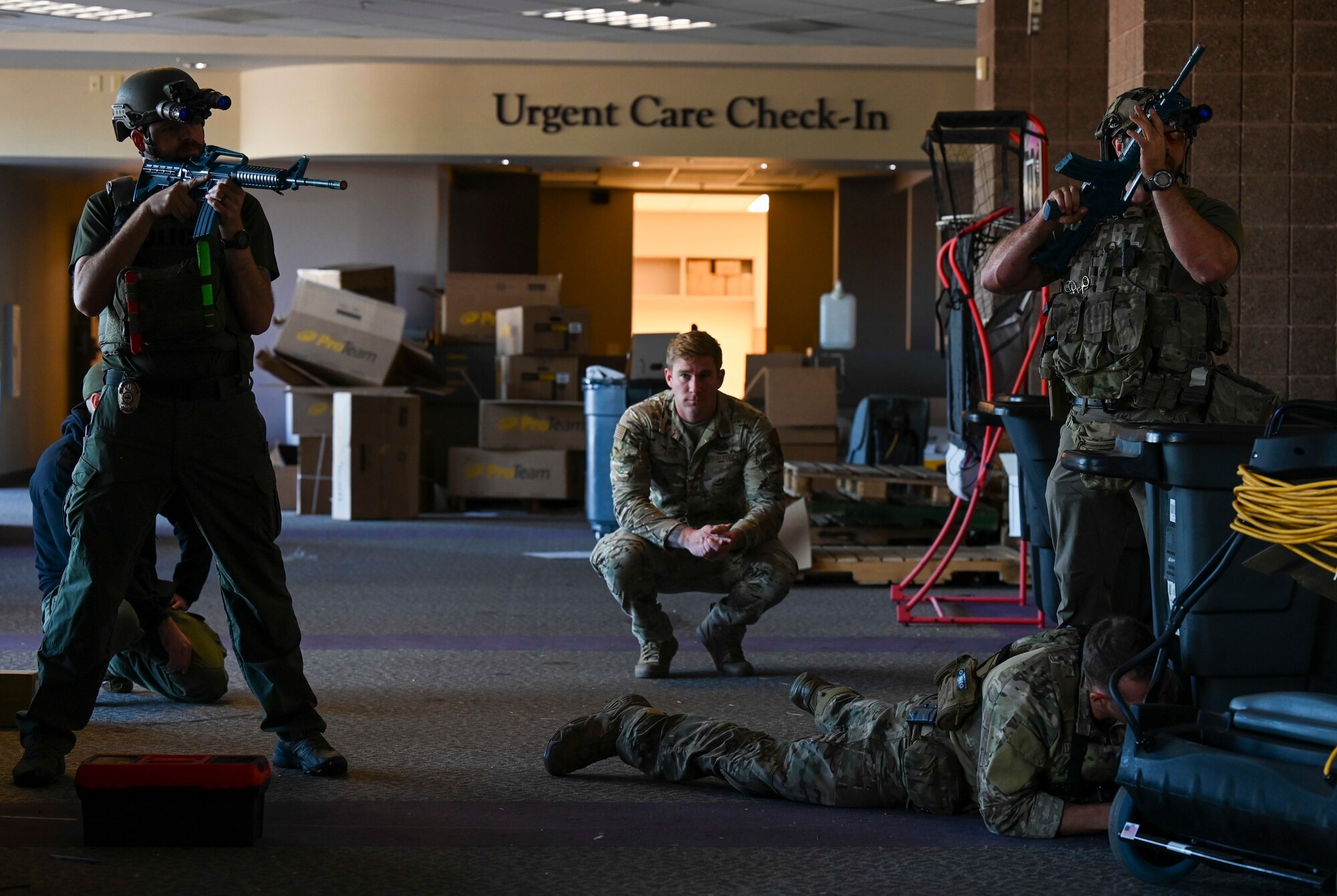 Air Force airmen and FBI members clear a room during a training scenario