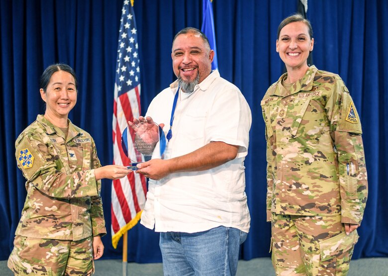 Col. Mia Walsh, Commander, Space Base Delta 3, presents the SBD 3 Civilian of the Third Quarter, Category V award, to Moises Rosales, Flight Chief of Military Personnel, SBD 3, for his outstanding achievements. CMSgt. Sarah R. L. Morgan, right, Senior Enlisted Leader, SBD 3, joins in the award presentation at the SBD 3 All Call on Los Angeles Air Force Base. (U.S. Space Force photo by Van Ha).
