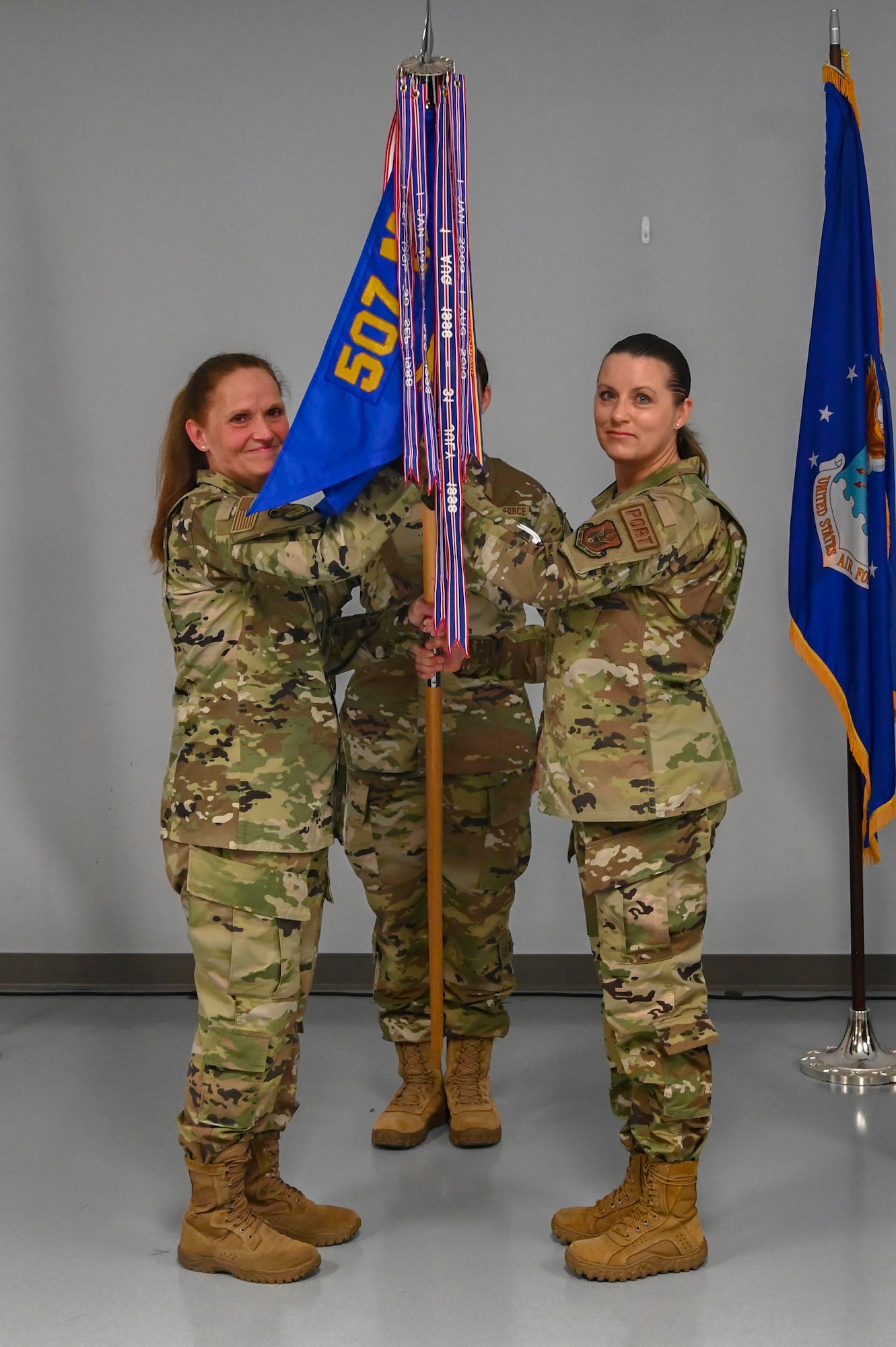 two women hold flag