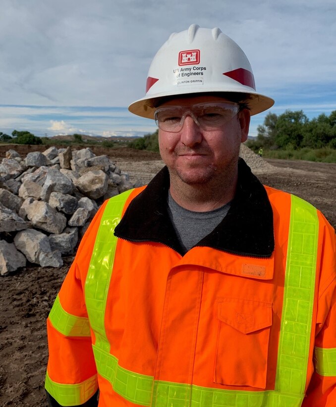 Clinton Griffin, quality assurance representative with the Los Angeles District, observes embankment construction Oct. 4 in Duncan, Arizona. Clinton deployed along the Gila River to support emergency flood response efforts after severe flooding damaged critical infrastructure in in the small eastern Arizona town.  Clinton has been a U.S. Army Corps of Engineers employee for more 12 years.