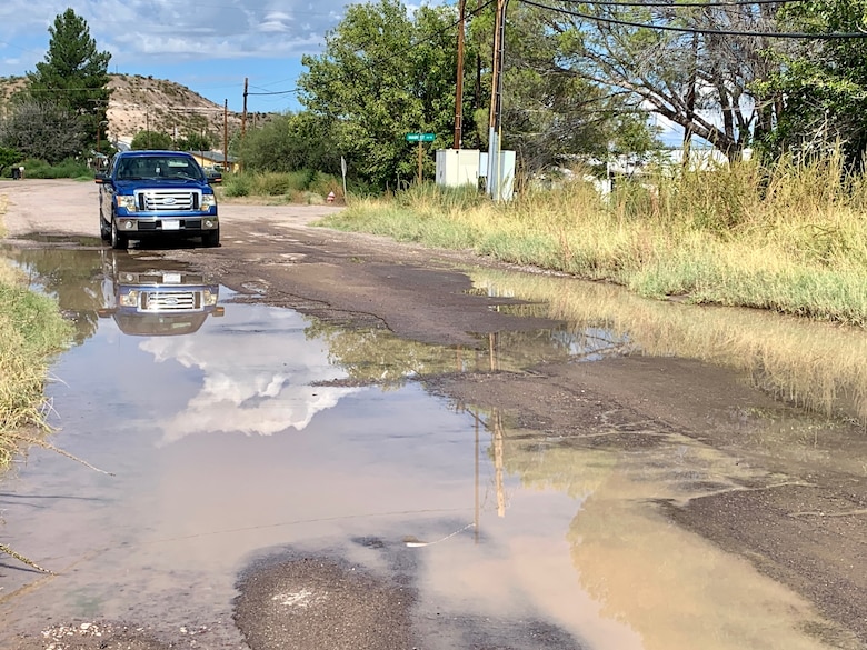 A driver navigates a washed-out road Oct. 5 in Duncan Arizona. The town was still saturated with water from an Aug. 22 flood event.