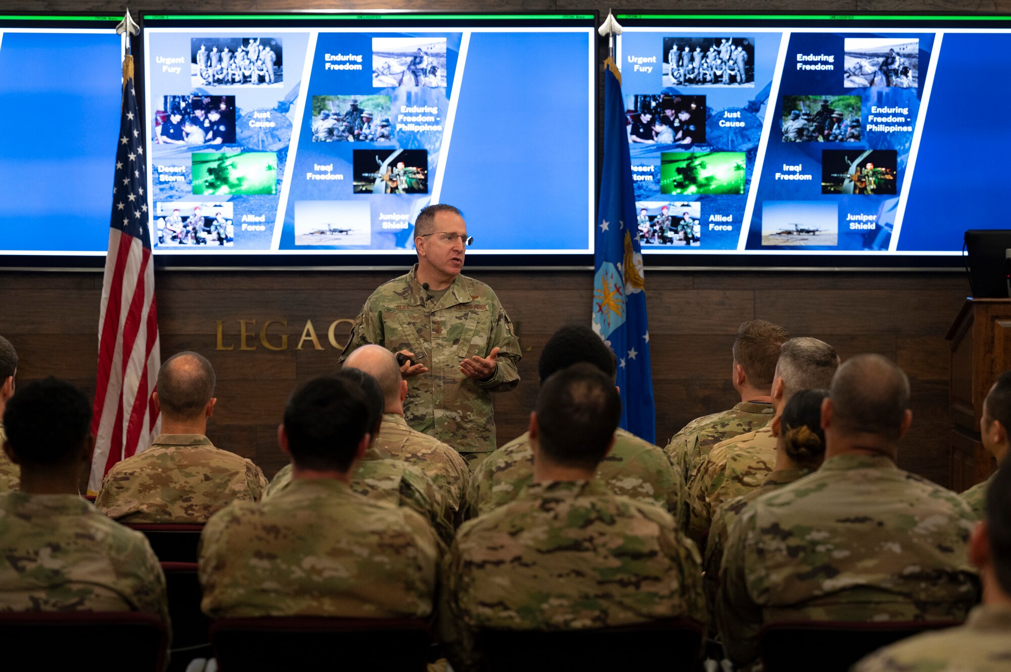 A group of Airmen listen during a presentation.