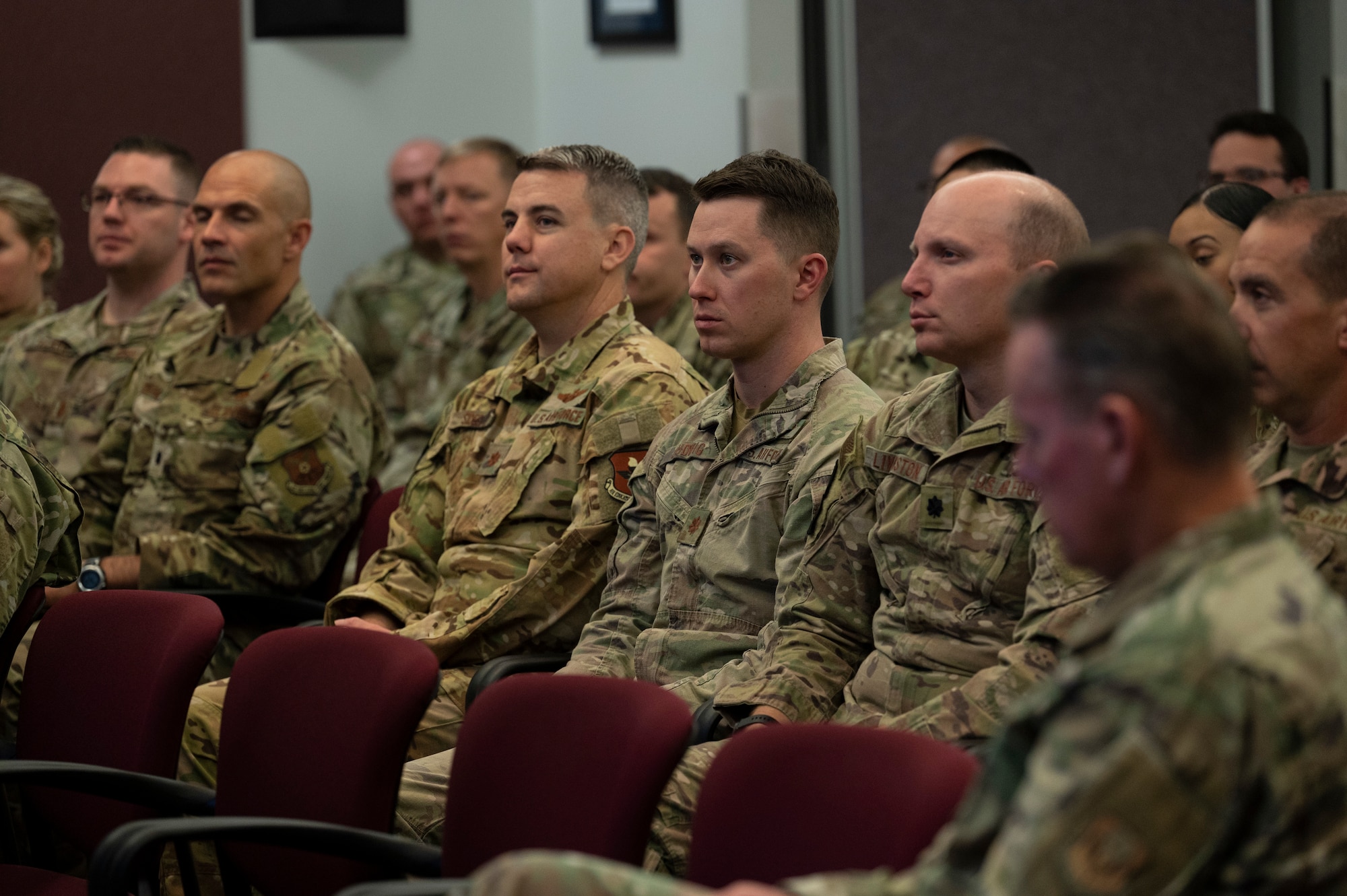 A group of Airmen listen during an all-call.
