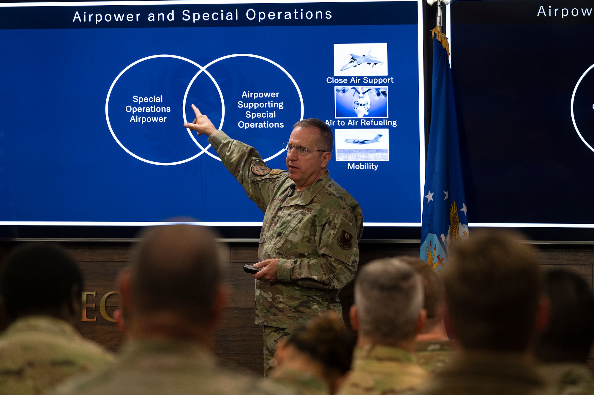 A man points at a screen.