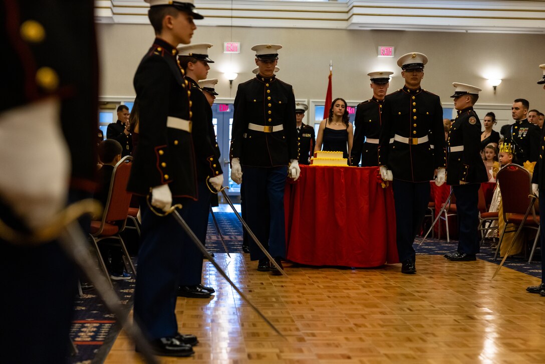 Marine Corps Junior Reserve Officer Training Corps cadets with the Quantico Middle/High School present the cake for the cake cutting ceremony during the military family dance night held at The Clubs at Quantico, Marine Corps Base Quantico, Virginia, Nov. 2, 2022. The dance provided the opportunity for children to celebrate the Marine Corps birthday as well as share in the experience of a night like the experiences of the actual Marine Corps birthday ball. (U.S. Marine Corps photo by Lance Cpl. Joaquin Dela Torre)