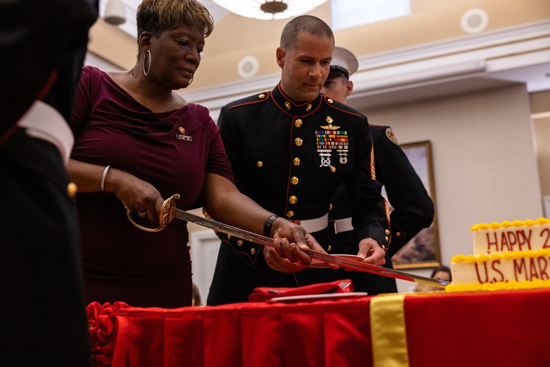 Retired U.S. Marine Corps Sgt. Maj. Parisa Fetherson, the Marine Corps Community Services representative, left, cuts the birthday cake with U.S. Marine Corps Sgt. Maj. Collin D. Barry, sergeant major, Marine Corps Base Quantico, during the military family dance night held at The Clubs at Quantico, Marine Corps Base Quantico, Virginia, Nov. 2, 2022. The dance provided the opportunity for children to celebrate the Marine Corps birthday as well as share in the experience of a night like the experiences of the actual Marine Corps birthday ball. (U.S. Marine Corps photo by Lance Cpl. Joaquin Dela Torre)