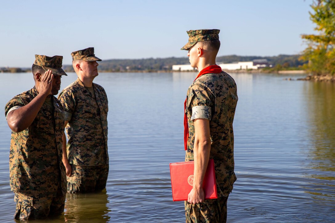 U.S. Marine Corps Cpl. Caden Phillips, a combat videographer, renders a salute to Capt. Michael Curtis, a Communications Strategy Operations officer both with Security Battalion, during his promotion to corporal on Marine Corps Base Quantico, Virginia, Oct. 7, 2022. Promotion ceremonies are a significant achievement in a service member’s career and are a testament to their commitment, mastery of duties and skills, and leadership capabilities. Marines take on greater responsibilities as Non-Commissioned Officers after showing exemplary leadership skills. Phillips requested to be promoted to corporal in the Potomac River, following the Marine Corps' traditions. (U.S. Marine Corps photo by Lance Cpl. Joaquin Dela Torre)