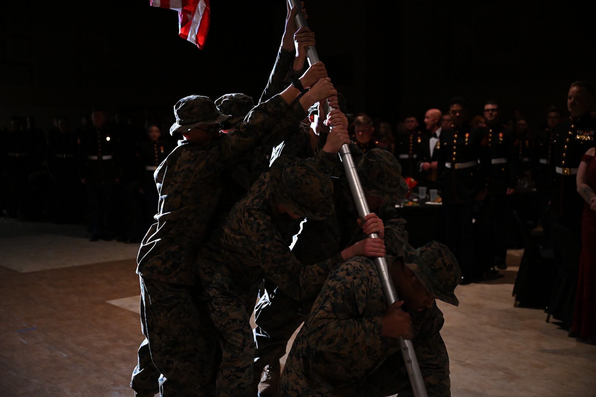 Marines assigned to Marine Corps Detachment Goodfellow recreate the famous scene of raising the American flag after the victory at Iwo Jima during the opening ceremonies at the McNease Convention Center, San Angelo, Texas, Nov. 4, 2022. The opening ceremonies consisted of various events paying homage to the 247-year-old history of the United States Marine Corps. (U.S. Air Force photo by Senior Airman Michael Bowman)