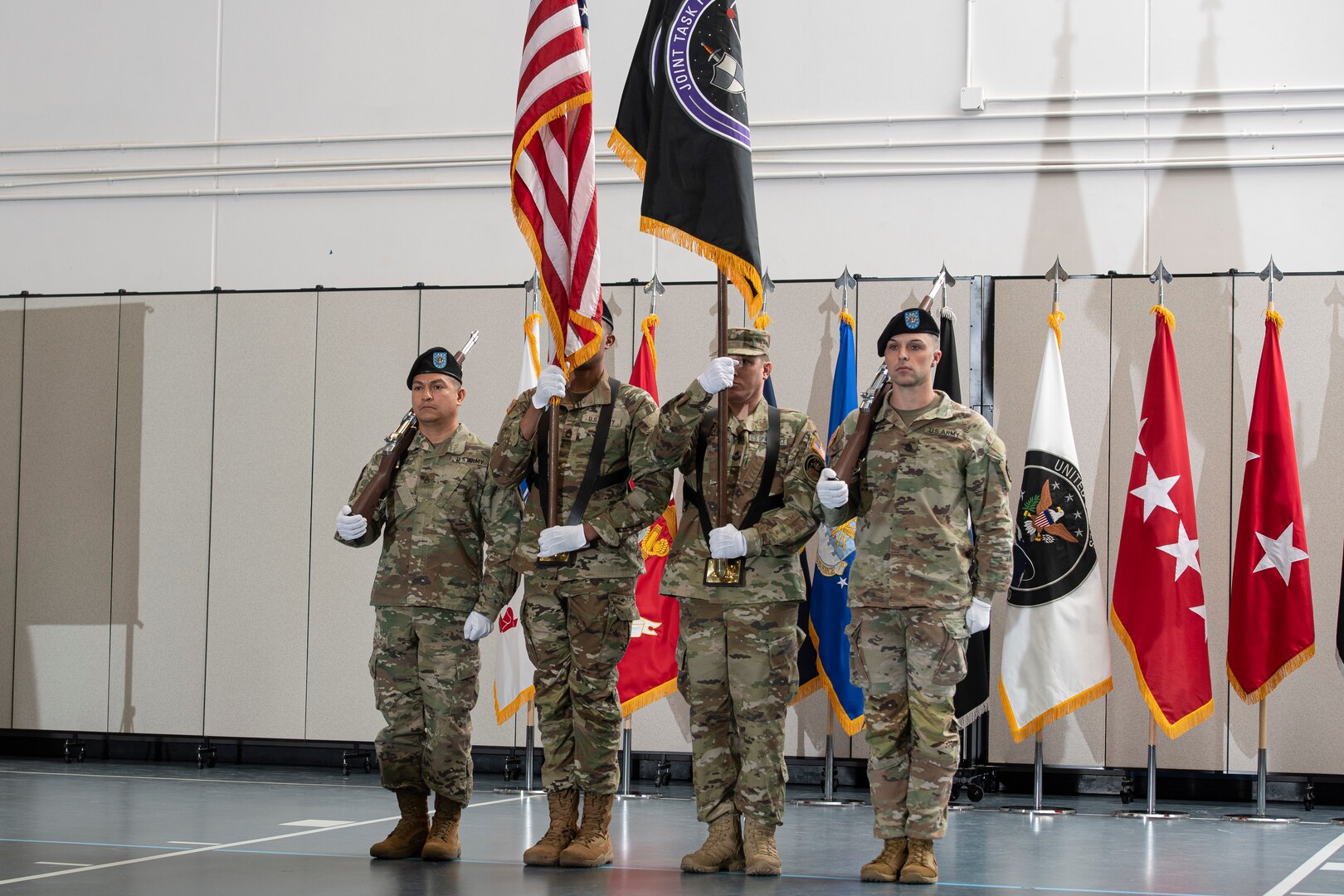 Military color guard stands at attention