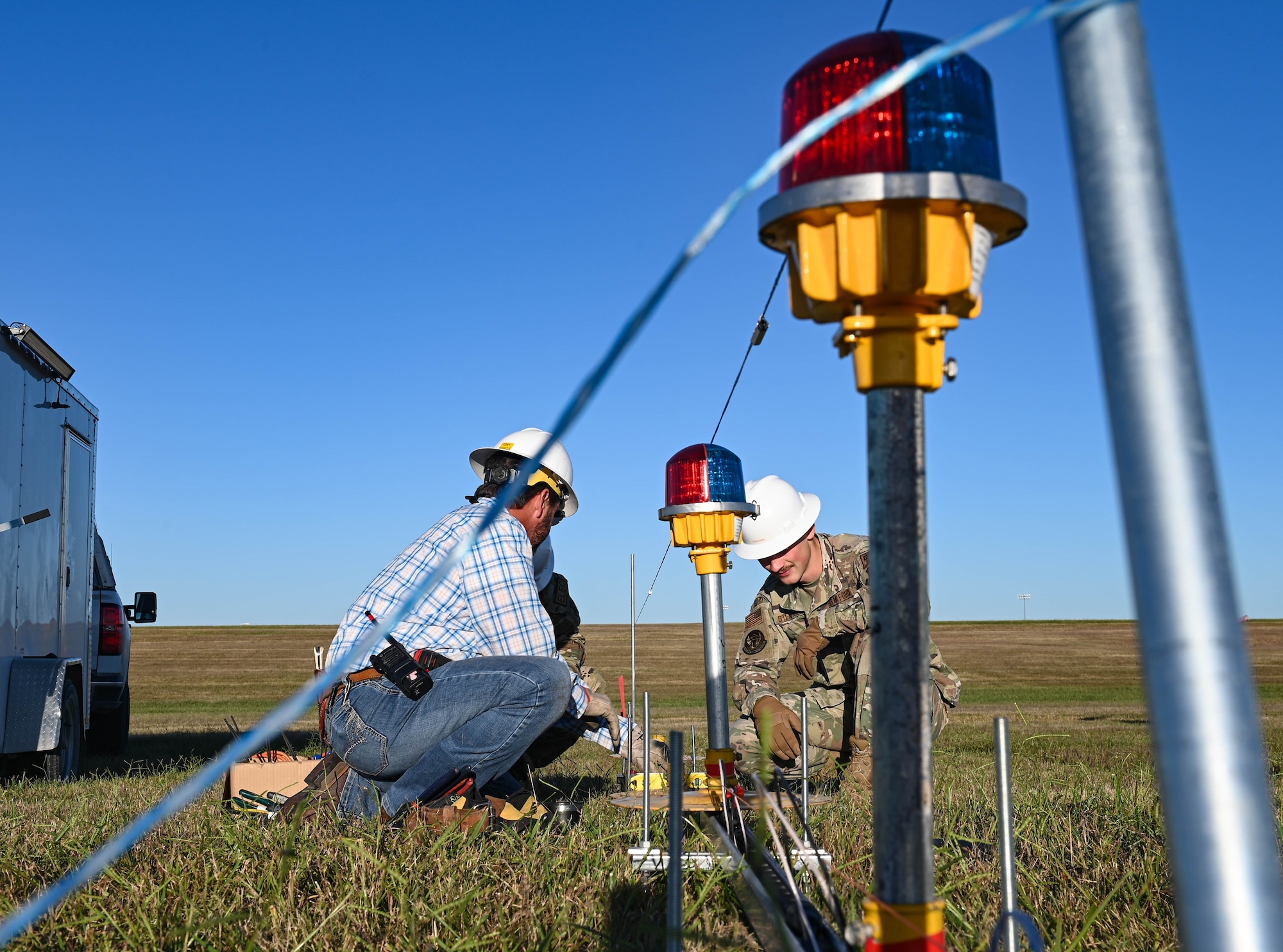 U.S. Air Force Airman 1st Class Gordon Stenersen, 509th Civil Engineer Squadron Electrical Systems Craftsman, right, and Tony Morris, High Voltage Technician, left, install and level the temporary winged-out threshold bar at Whiteman Air Force, Missouri, September 26, 2022. (U.S. Air Force photo by Airman 1st Class Hailey Farrell)